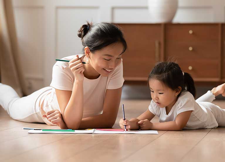 Mom and daughter coloring while on the floor.  -767x554.jpg 