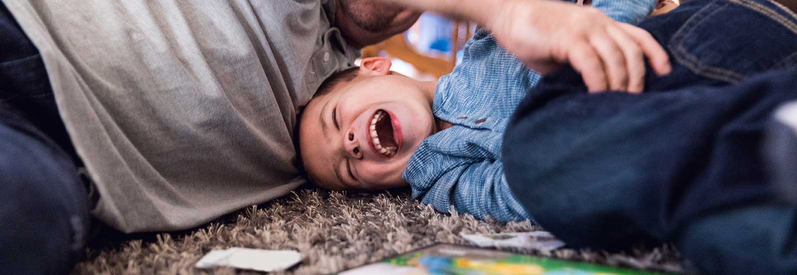 Father and son play on the floor. -767x554.jpg