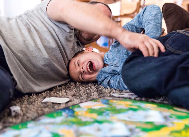 Father and son play on the floor. -767x554.jpg